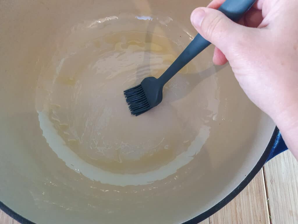Greasing Dutch oven with a little oil.