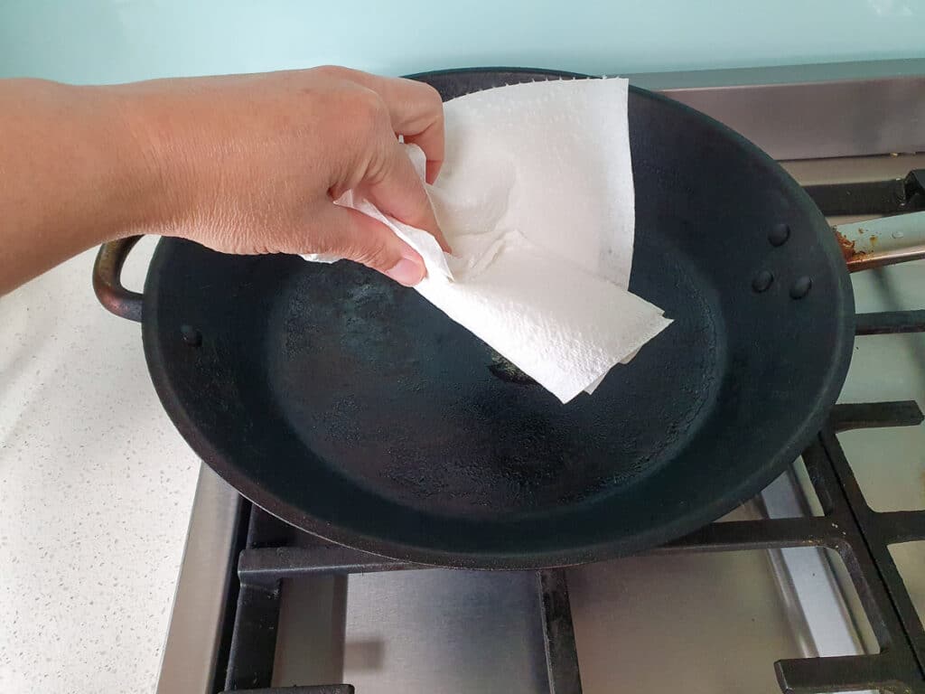 Wiping out first knob of butter carefully with paper towl.