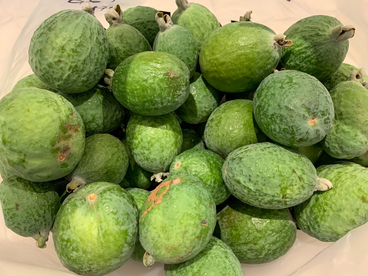 Large pile of feijoas.
