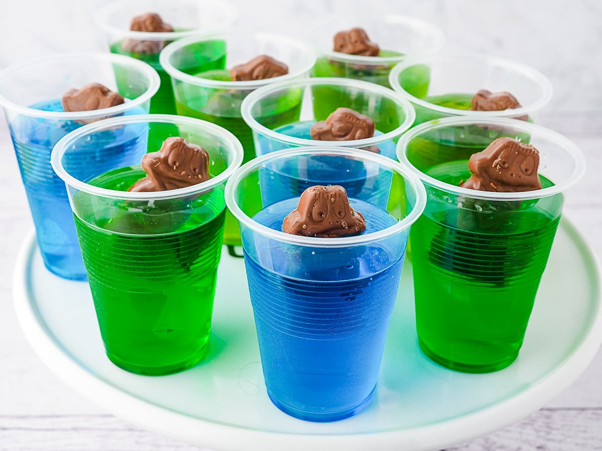 Several jelly cups on a plate.