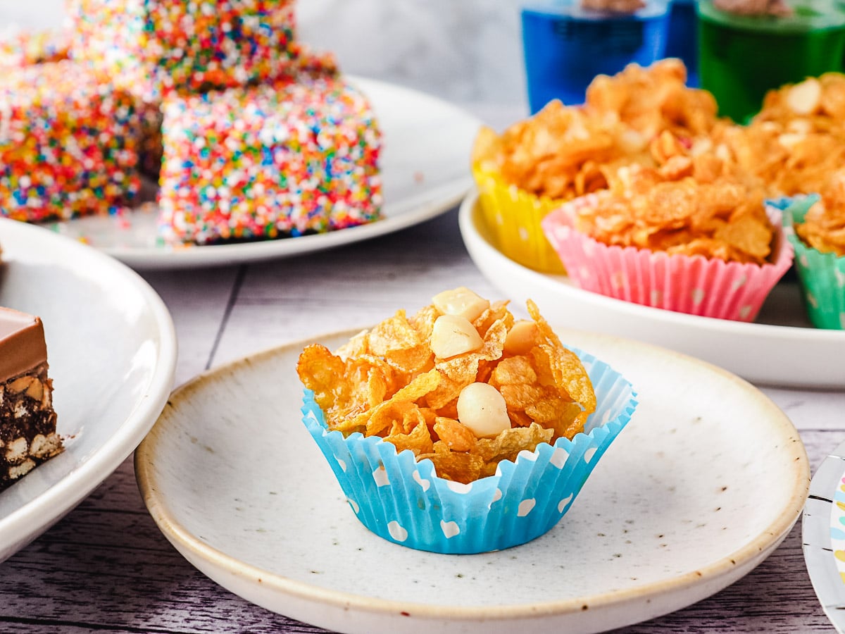 Honey joy on a plate with party food in background.